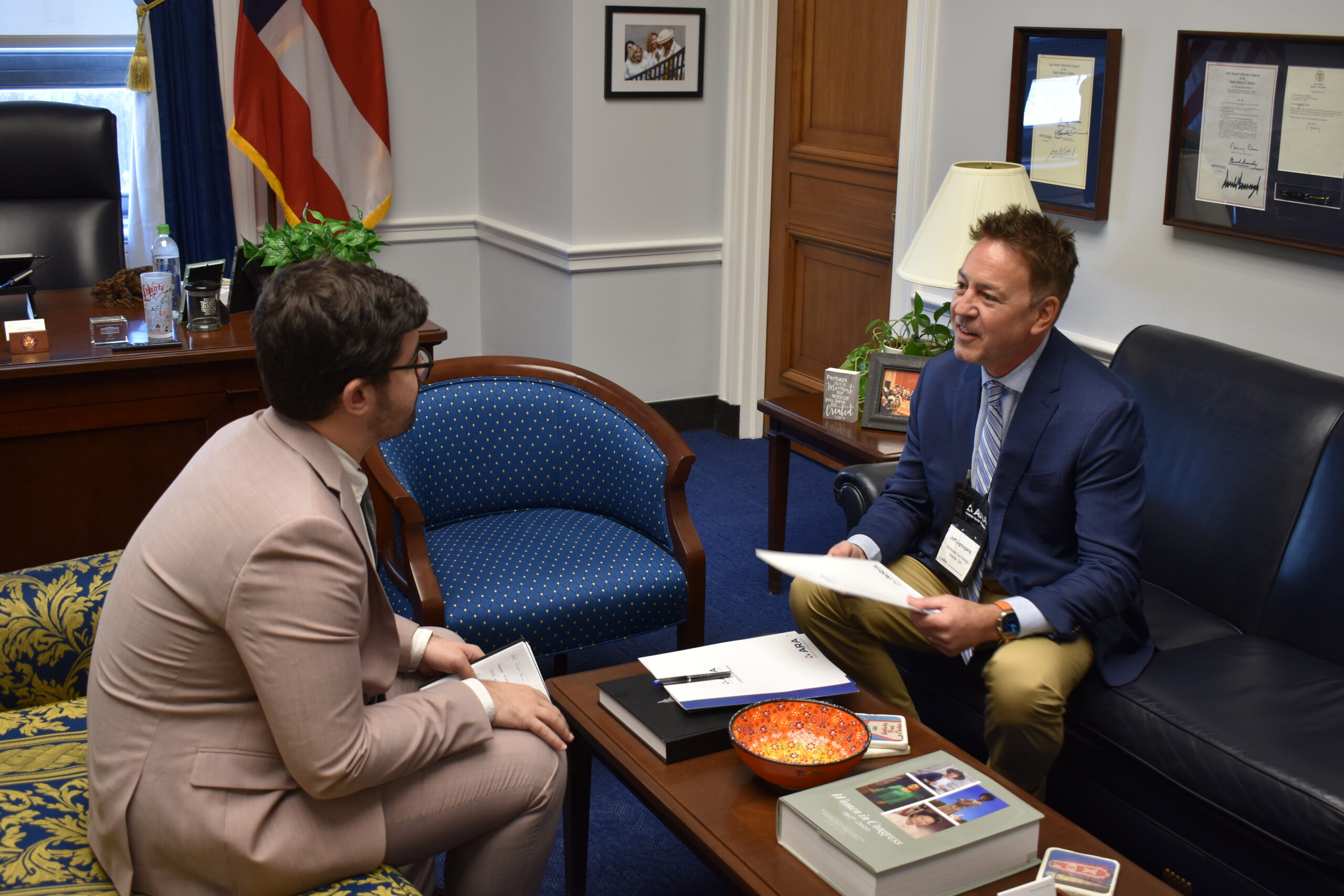 Jeff Lignugaris, right, speaks with a congressional staffer